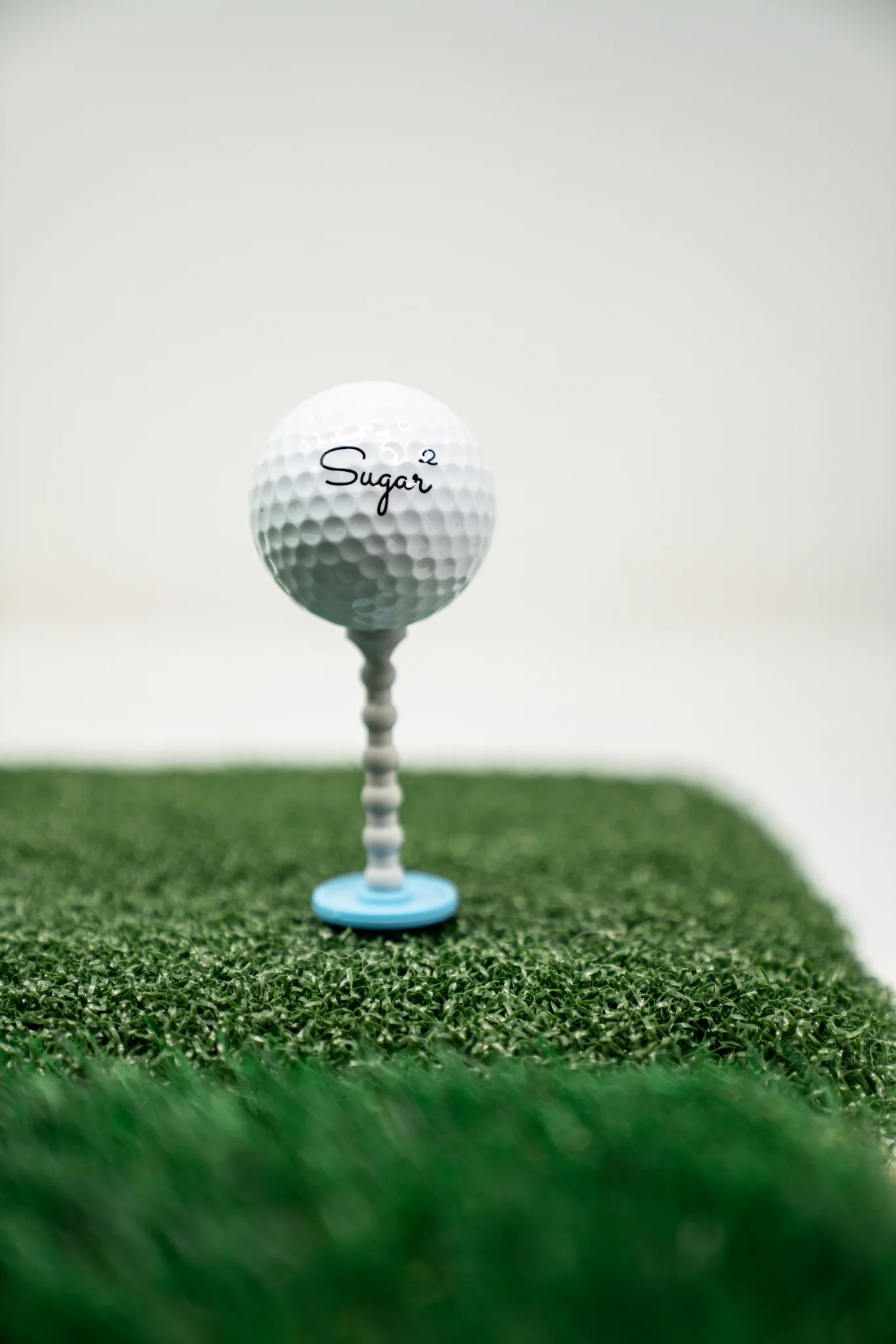 Golf ball on close-cut green at golden hour